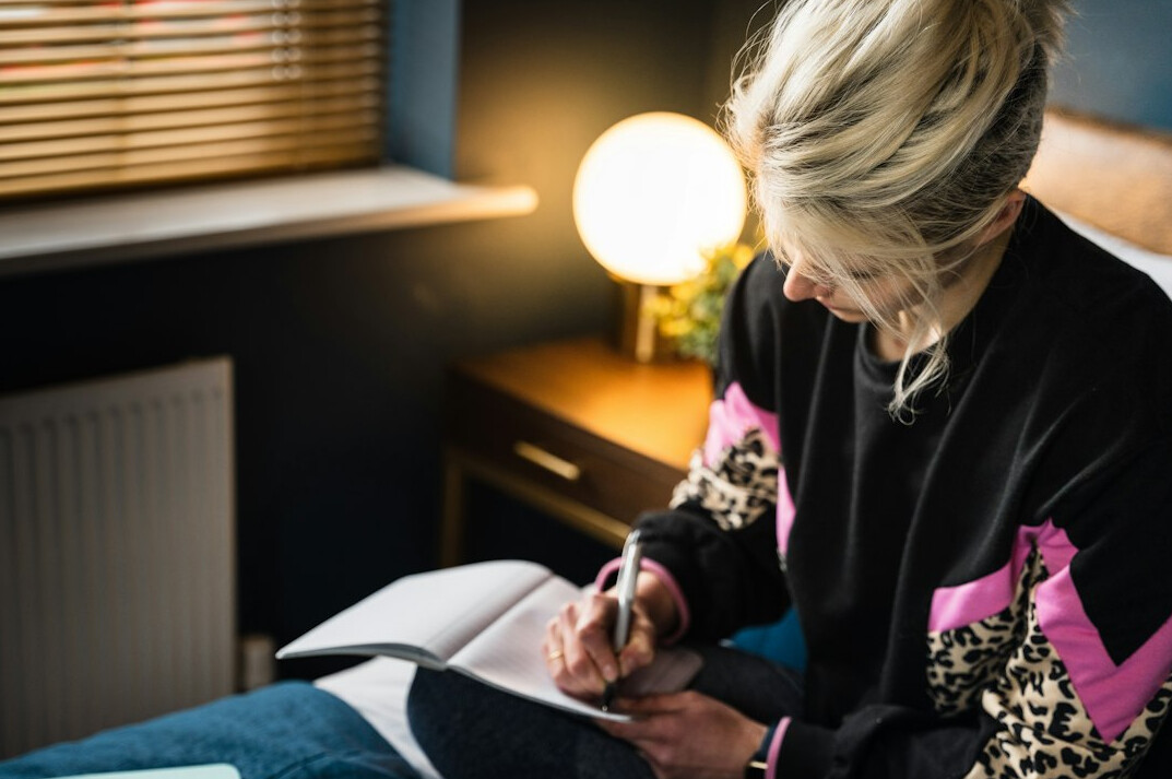 woman writing in journal