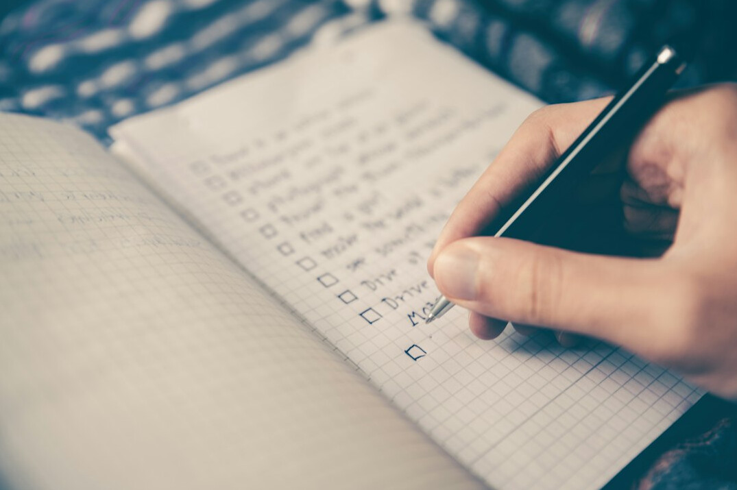 person tracking habits in notebook