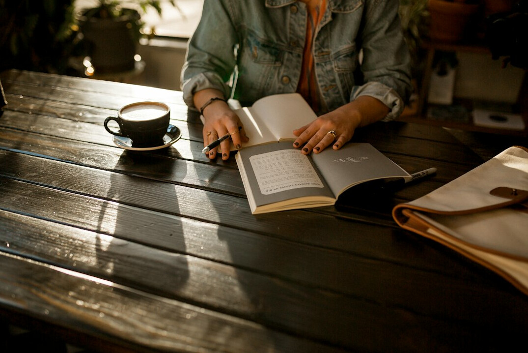 person writing in journal morning